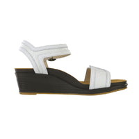 Wedge sandal with white straps and buckle accent.