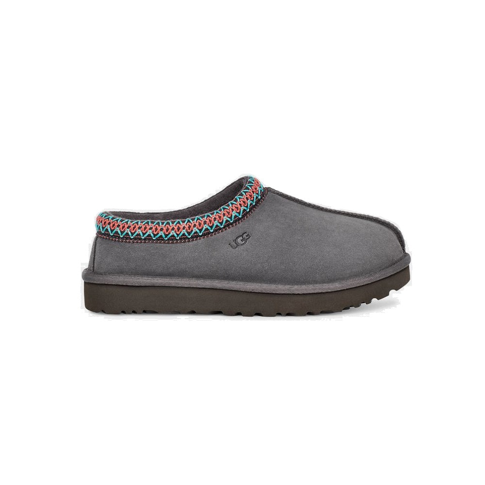 UGG Tasman slipper in dark grey with blue and pink braided trim.